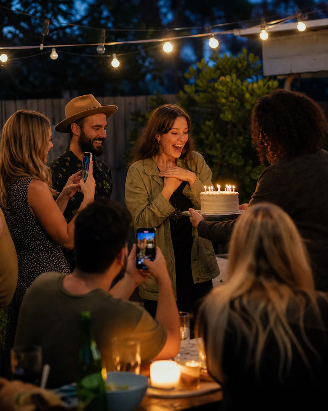 Friends photographing a birthday celebration