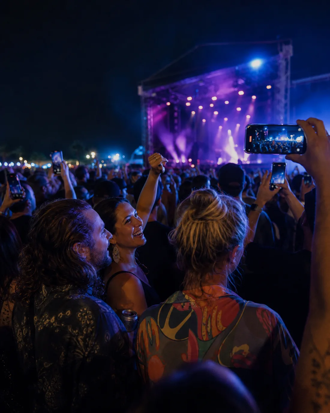 Friends capturing a festival performance from within the crowd